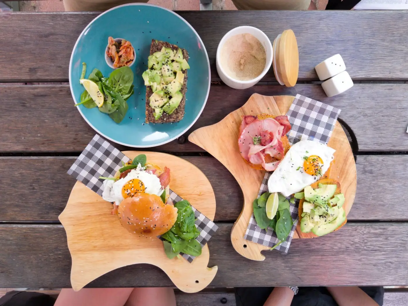 Brunch spread with smashed avocado, poached eggs and coffee at Four Birds Cafe