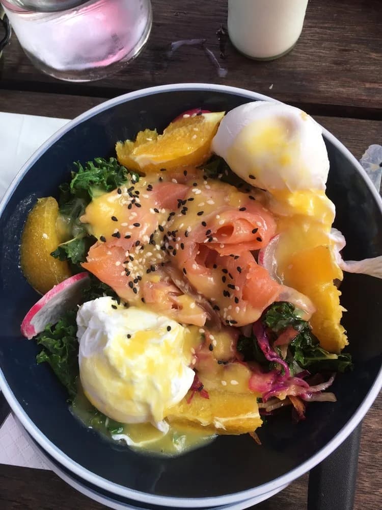 Salmon energy bowl with poached eggs and greens
