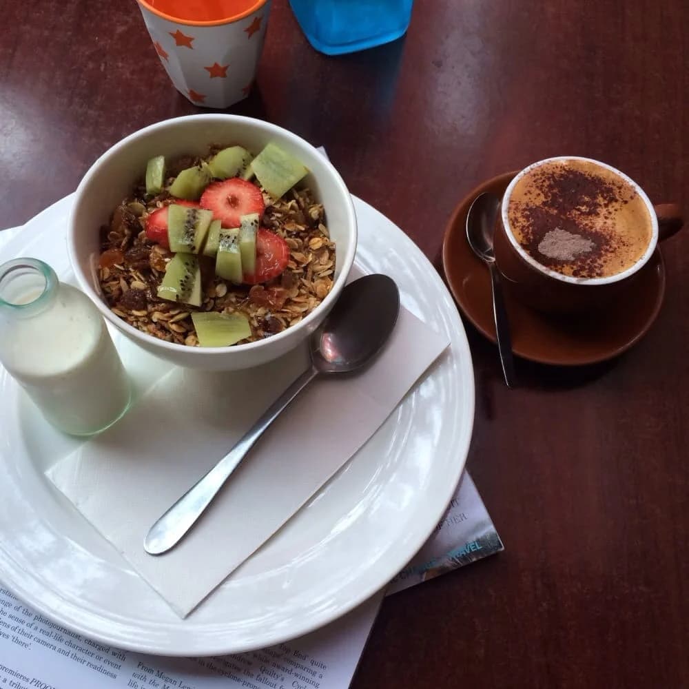 Muesli with fresh fruit and cappuccino